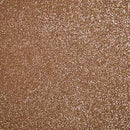 Tekstureret overflade med pink glimmer, der skaber en skinnende og glitrende effekt.