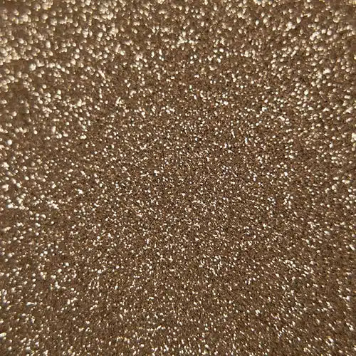 Tekstureret overflade med lys, varm glitter, der skaber en skinnende og reflekterende effekt.