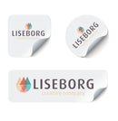 Tre klistermærker med LISEBORG logo: firkantet, rundt, rektangulært. Alle har afpillet hjørne.